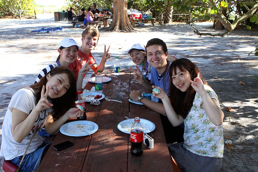 Saki Nagai, 19, Naraumi Yasuda, 21, J.D. Kurman, 16, Natsumi Yasuda, 23, Cold Lyman, 17, and Chigusa Maruyama, 19, all flash the peace sign, Sunday, March 25.