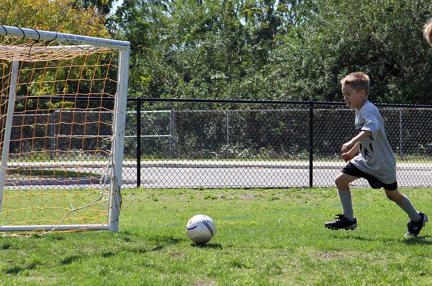 Luca Miccio, 4, gets ready to score a goal for his team the Blue Dolphins.