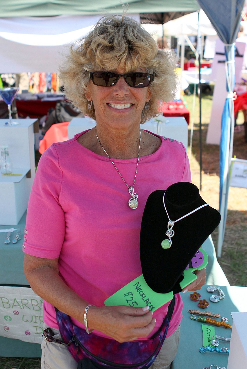 Barby Comins shows off some of her barbed wire creations.