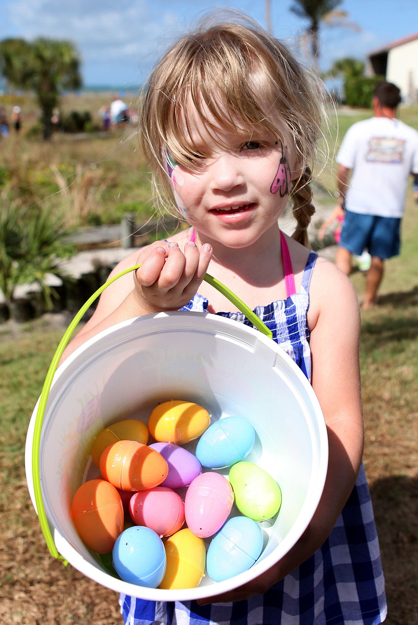 Harper Kipker, 3, shows off all the eggs she found during the egg hunt.