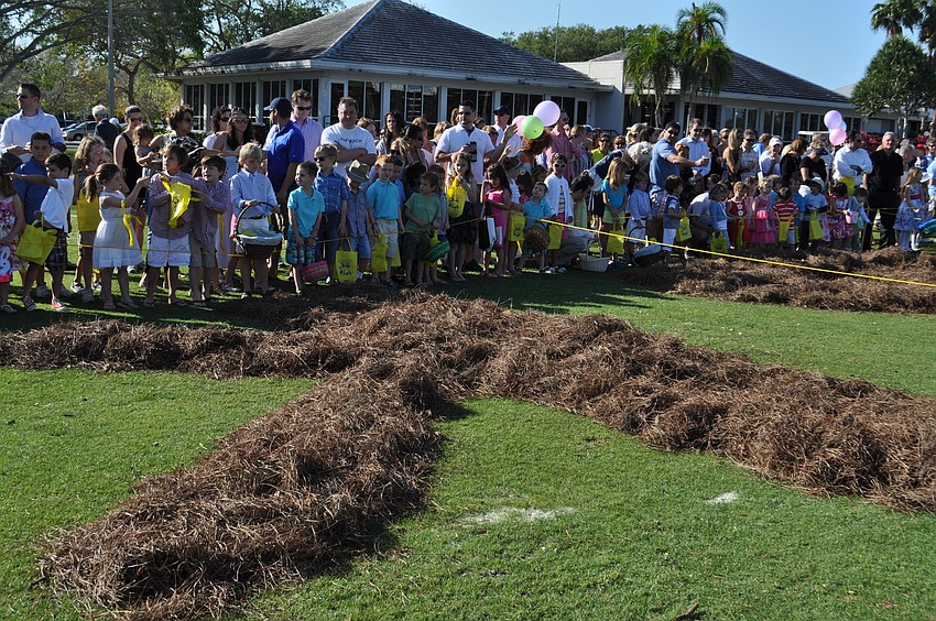 Children line up waiting to dig up Eggs