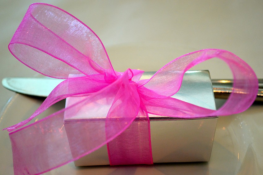 Guests received party favors wrapped with pink bows.
