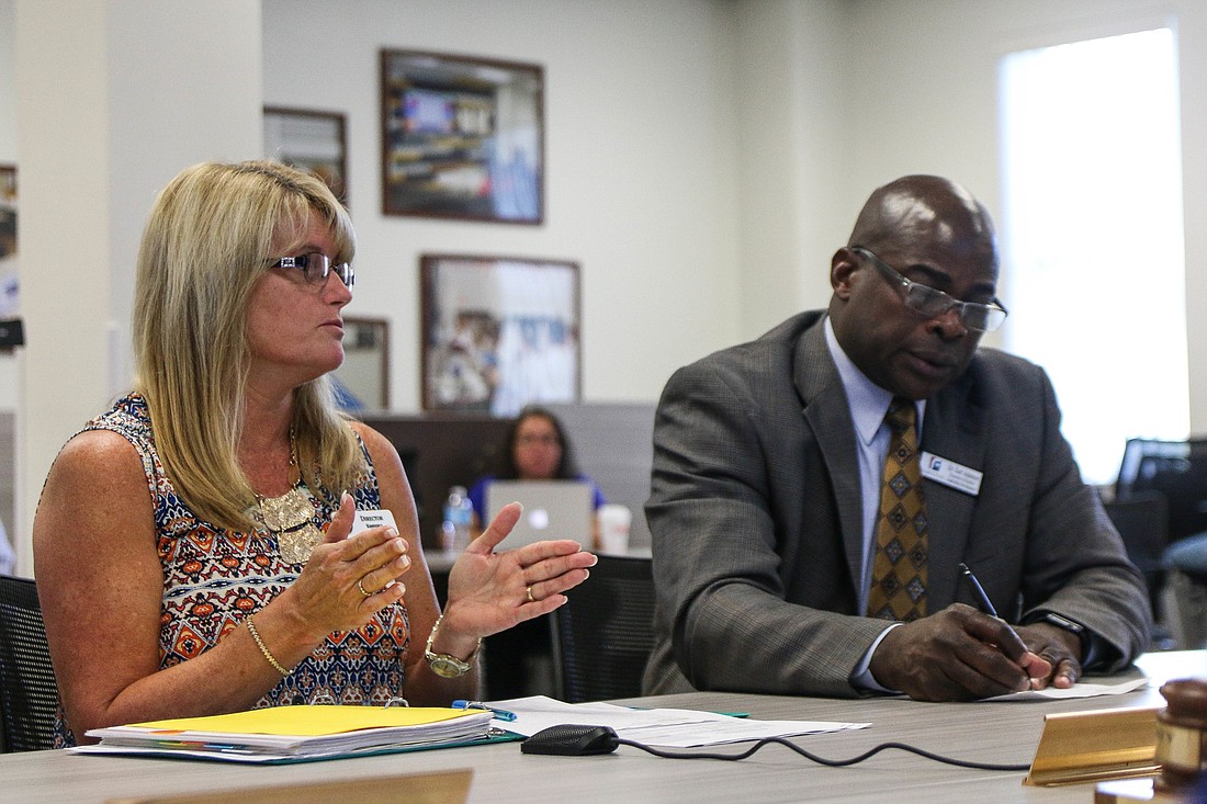 Kim Hale, PAL director, and Earl Johnson, executive director of leadership development, speak to the School Board about the middle school sports plan. Photo by Paige Wilson