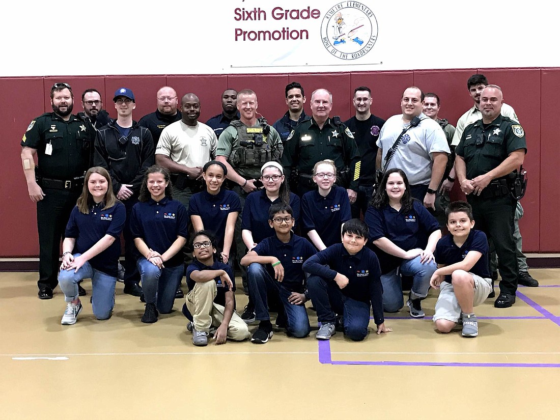 The Hero Squad poses with first responders during Game Night, one of seven events at Rymfire Elementary School throughout the school year. Courtesy photos