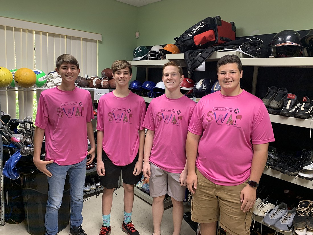 Tommy Sturman, Aiden White, Ben Kopach and Jake Blumengarten collected about $12,000 worth of used sports equipment to give away in the SWAP shop. Courtesy photo