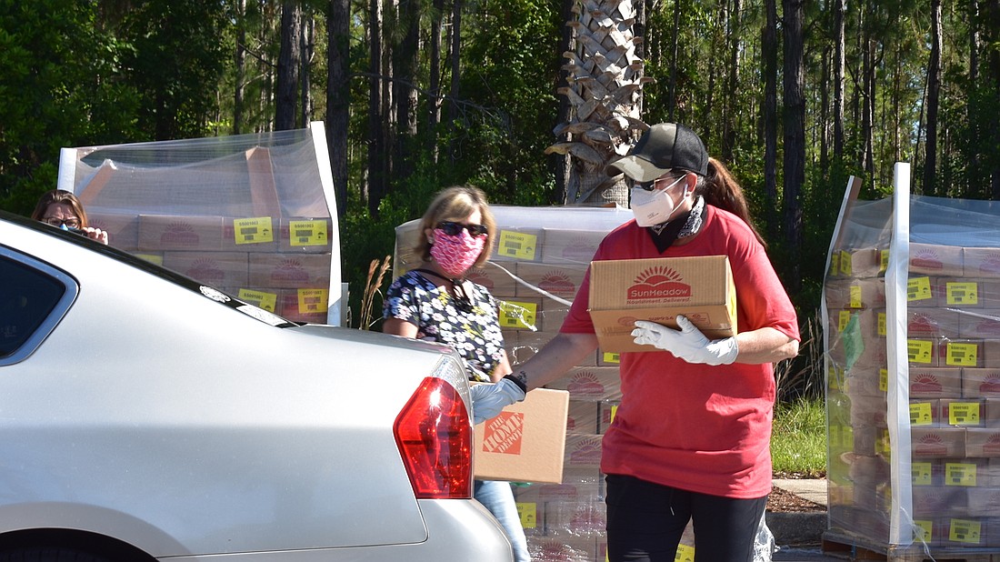 Mayor Milissa Holland helps distribute food at Feed Palm Coast. Courtesy photo