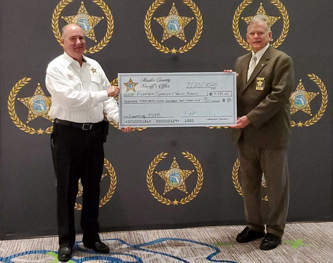 Sheriff Rick Staly presenting the check to FSYR Board Chairman Levy County Sheriff Bobby McCallum. Courtesy photo