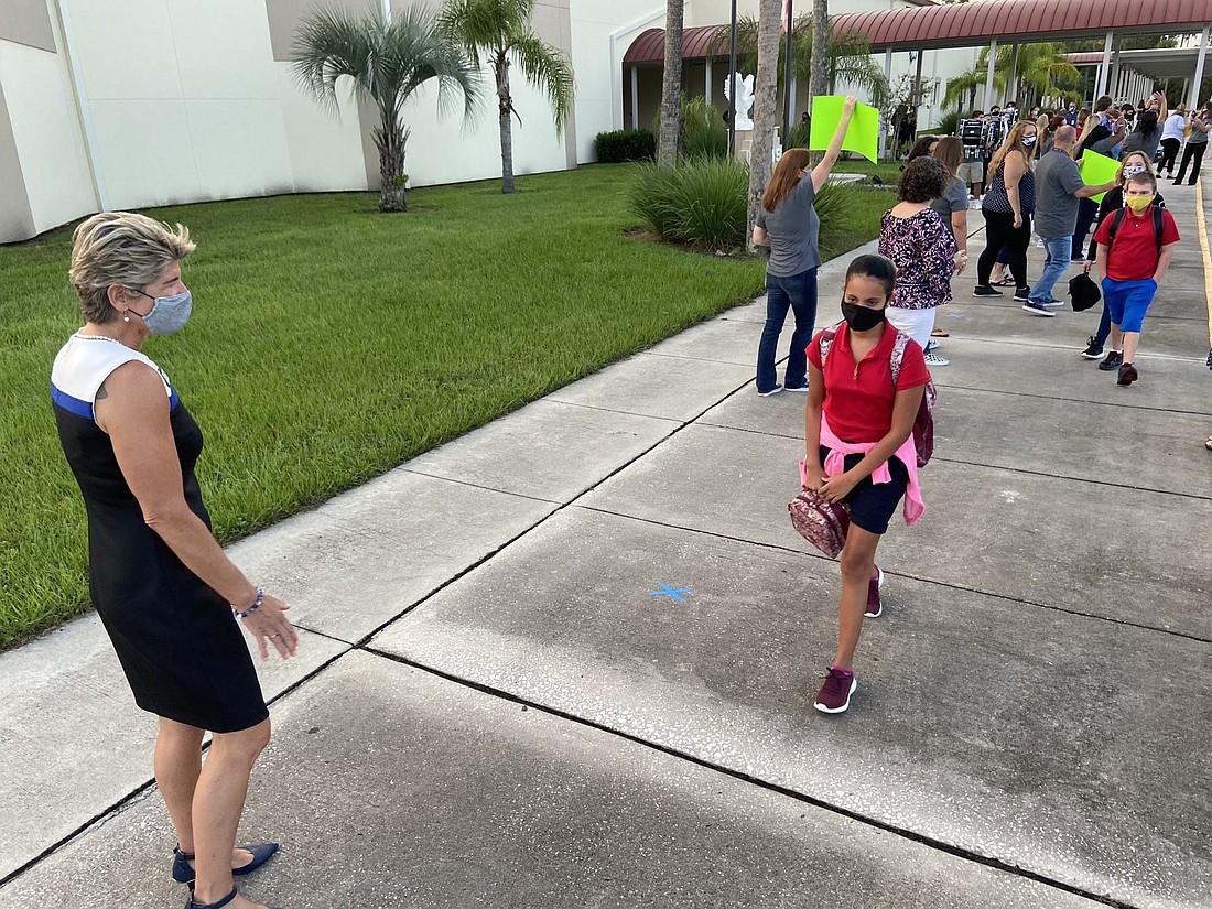 Flagler School Superintendent Cathy Mittelstadt welcomes students back to Belle Terre Middle School. Image from @FlaglerSchools official Twitter feed