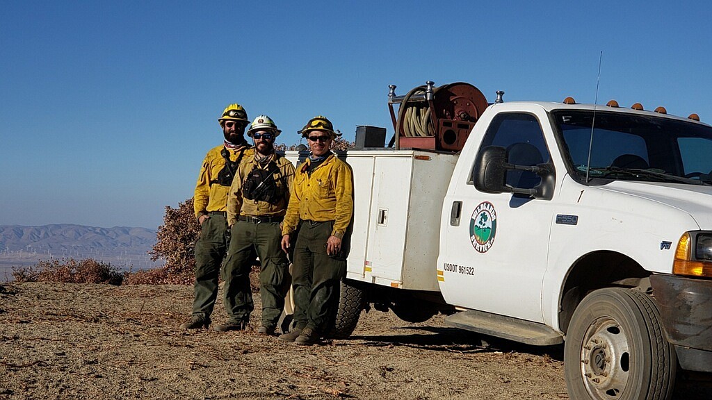 Firefighter Mike Orlando, in the white helmet, is fighting a wildfire in California. Image courtesy of the Flagler County government