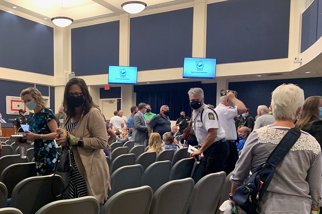 When a small group of residents refused to put on masks in a crowded commission meeting, defying the county's rules, Commission Chairman David Sullivan recessed the meeting and ordered everyone out of the room.