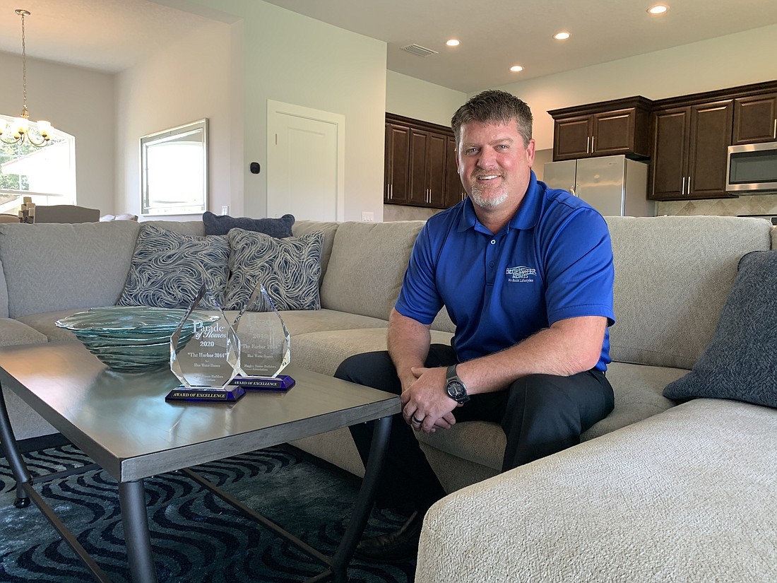 Jay Curbow, president of Blue Water Homes, poses at the model home on Bud Hollow Drive. Another model is under construction on La Mancha Drive. Photo by Brian McMillan