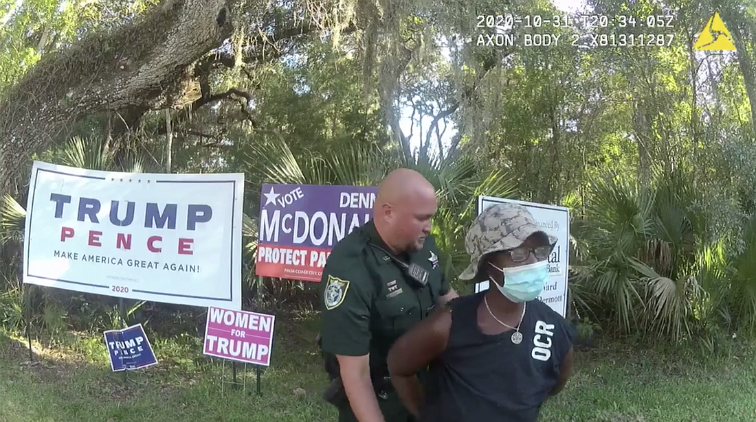 Tonya McRae was charged with criminal mischief and providing a false name to law enforcement after removing and damaging Trump campaign signs. Image from FCSO body camera stream