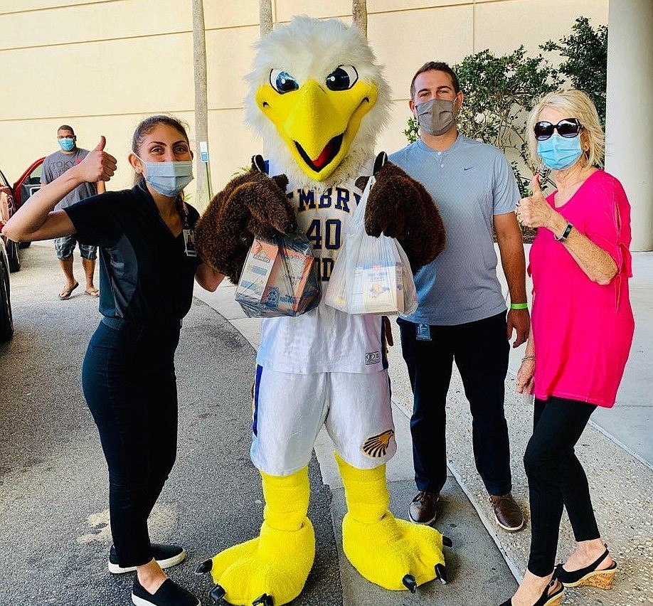 From left: Ida Babazadeh, Outreach Representative, Marketing & Public Relations, Advent Health, ERAU Eagle, Mitchell VanSumeren, Director of Sports Marketing and Promotions, ERAU, and Judi Winch, Executive Director, Food Brings Hope.  Courtesy photo.