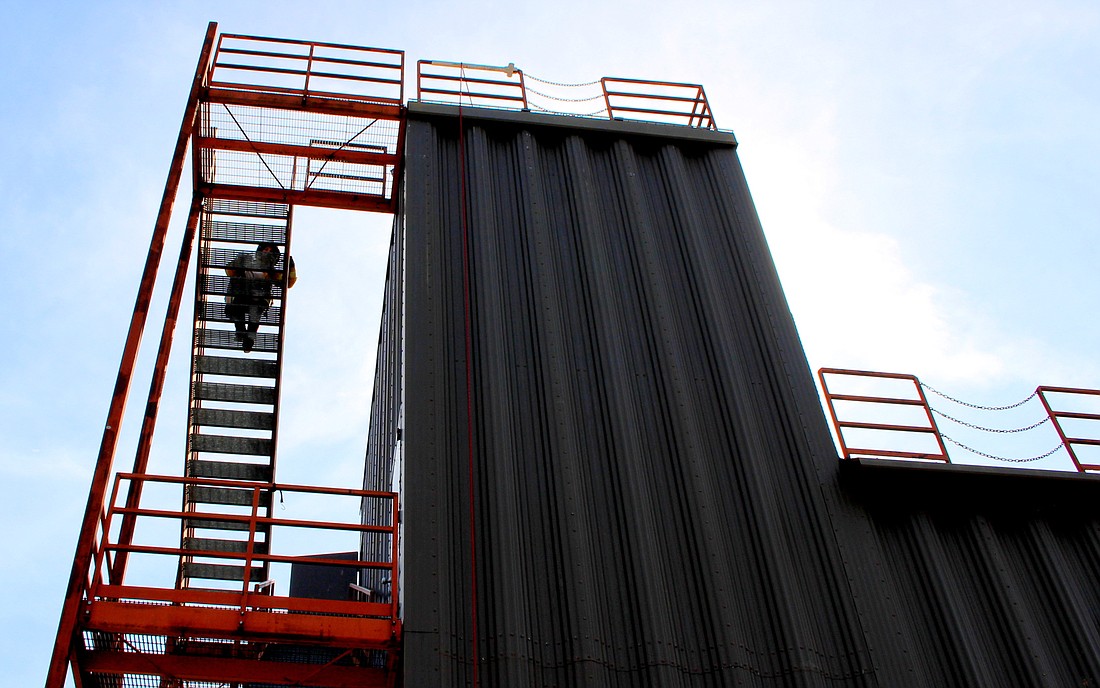 A firefighter ascends the training tower. Photo courtesy of the Flagler County government