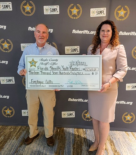 Sheriff Staly presenting the employee donation to the FSYR Executive VP Maria Knapp. Courtesy photo