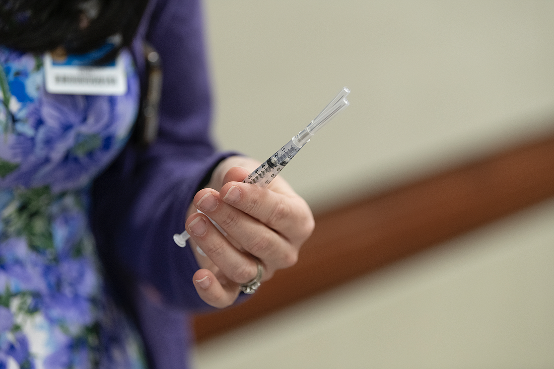 An AdventHealth staff member holds doses of COVID-19 vaccine. Photo courtesy of AdventHealth