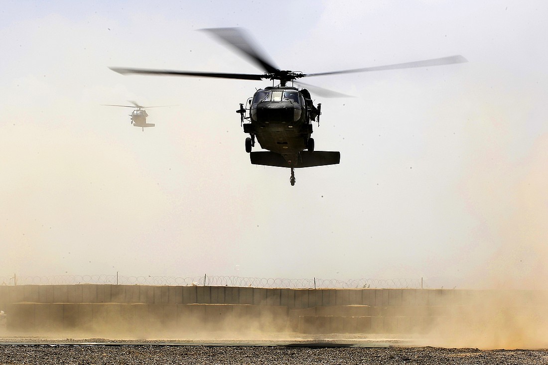 A UH-60 Black Hawk helicopter carrying U.S. Defense Secretary Robert M. Gates lands at a forward operating base in Afghanistan, June 6, 2011. Public domain photo from Wikimedia Commons
