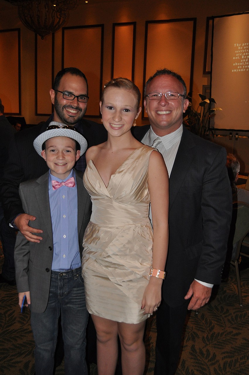 Roger Capote with Jim Wilson and his children, Brandon and Alexis