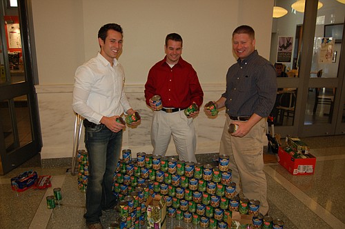 The Canstruction team from Bergmann Associates - Kyle Baker, Matt Meyer and Bob Hoppe - built a figure-eight roller coaster that's located near the Laura Street entrance of the Main Library.