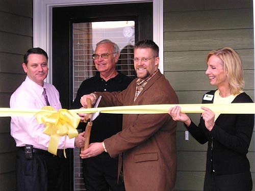 Collins Builders opened their newest development last month and leading officials in Baker County turned out for the occasion. The new Greystone community on U.S. 90 has 48 homesites and helping with the ribbon cutting were (from left) Mike Griffis, c...