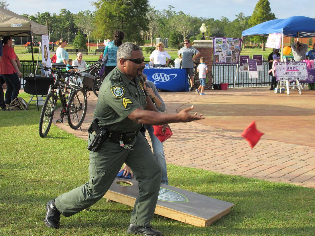 Flagler County Sheriff's Office Sgt. David Williams tries a beanbag toss at the 2015 National Night Out. (Photo courtesy of the Flagler County Sheriff's Office)