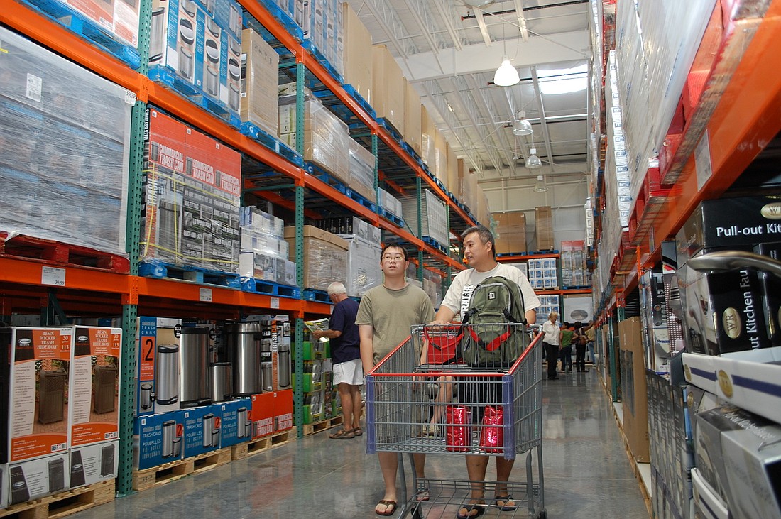 Nick Chin, and his father Getty, browse the selection of products at Costco, which opened today in Sarasota Square Mall.
