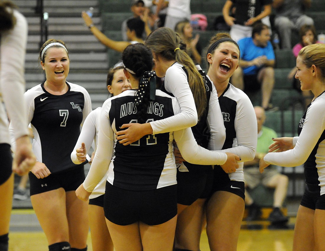 The Lakewood Ranch High volleyball team celebrates after defeating rival Braden River 23-25, 26-24, 25-23, 25-9 in its season opener Aug. 28.