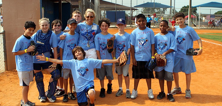 Donna McGarry poses with her team, the 1992 Blue Jays, during their World Series game against the Atlanta Braves Friday, April 29 out at Twin Lakes.