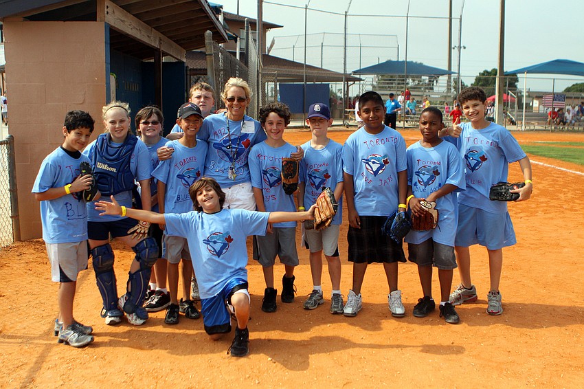 Donna McGarry poses with her team, the 1992 Blue Jays, during their World Series game against the Atlanta Braves Friday, April 29 out at Twin Lakes.