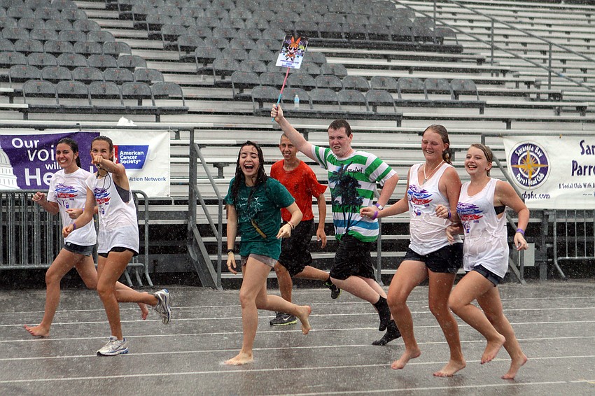 The Sarasota Teens With A Dream team continued to run their laps even during the downpour, Saturday, April 28, during the 2012 Relay for Life of Downtown Sarasota.