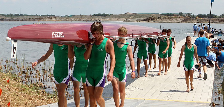 One of the Sarasota Scullers' Boys 8+ teams bring their boat in after a race, Saturday, April 28, at Nathan Benderson Park.