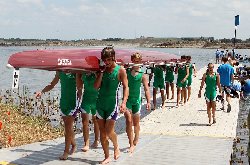 One of the Sarasota Scullers' Boys 8+ teams bring their boat in after a race, Saturday, April 28, at Nathan Benderson Park.