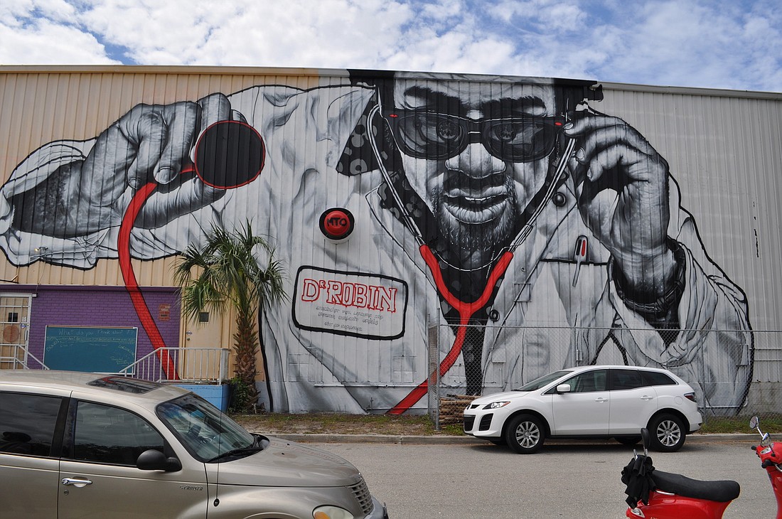 MTO's newest mural depicts a doctor in sunglasses holding up a stethoscope.