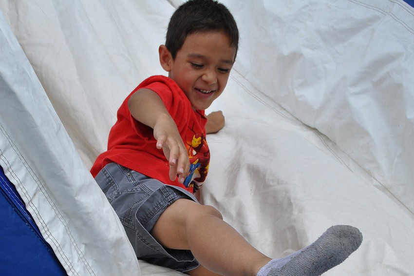 Robert Navarro, 5, raced down the slide with his friend, Jonathan Centeno, not pictured.