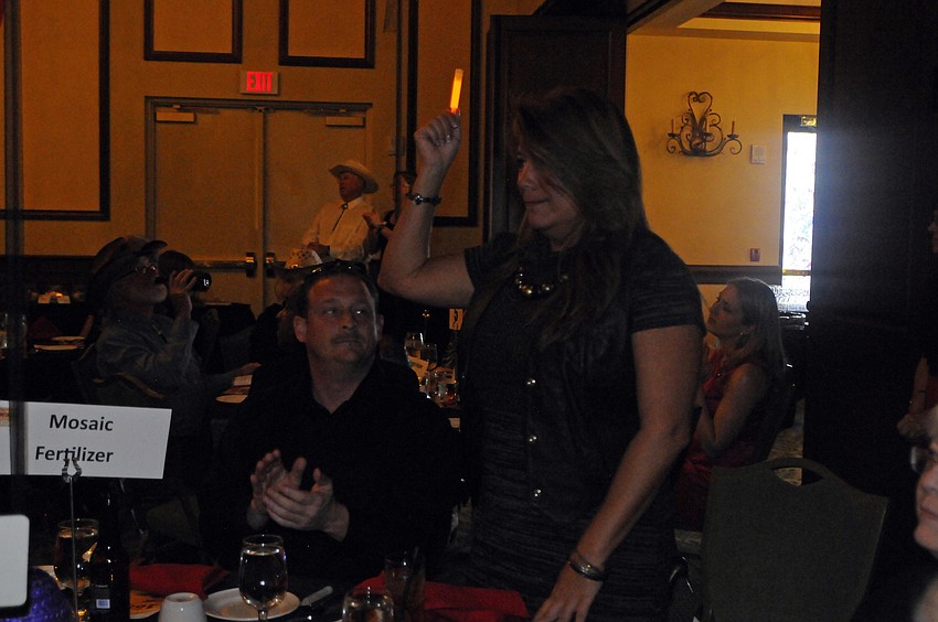 Promotion Notions owner Annette Guelil, pictured with her friend Chris Reynolds, raised a glow stick as a breast cancer survivor.