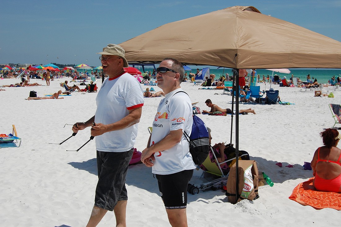 Jose Rocha (right), a professor of marketing at Florida International University, got a lesson from kite enthusiast Mark Williams.