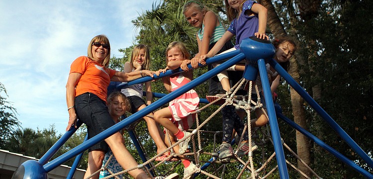 Frances Williams climbed up on the â€œspiderâ€ with some of the students, Saturday, May 5.