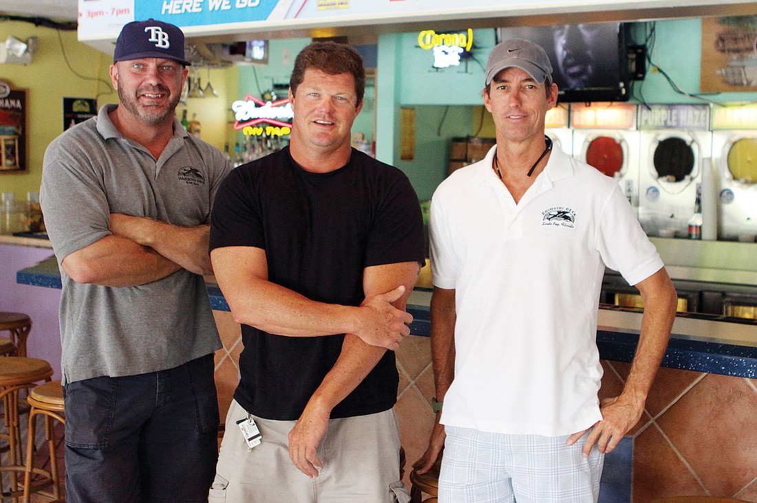 Matt Grover, Troy Syprett and Russell Matthes stand in front of the bar at Daiquiri DeckÃ¢â‚¬â„¢s Siesta Key location. Photo by Rachel S. O'Hara.