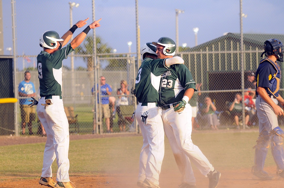 Brandon King, Justin Greenaway and Bryan Vanvranken celebrate after taking a 3-0 lead in the bottom of the first inning.