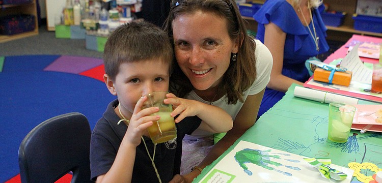 Ray Rini, 5, drinks his tea with his mom, Alison, Thursday, May 10.