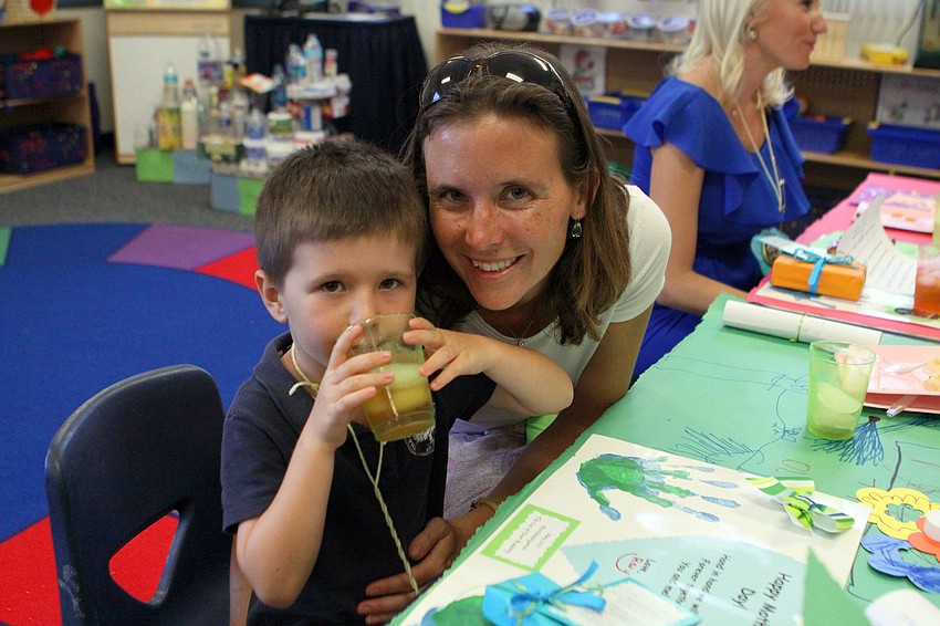 Ray Rini, 5, drinks his tea with his mom, Alison, Thursday, May 10.