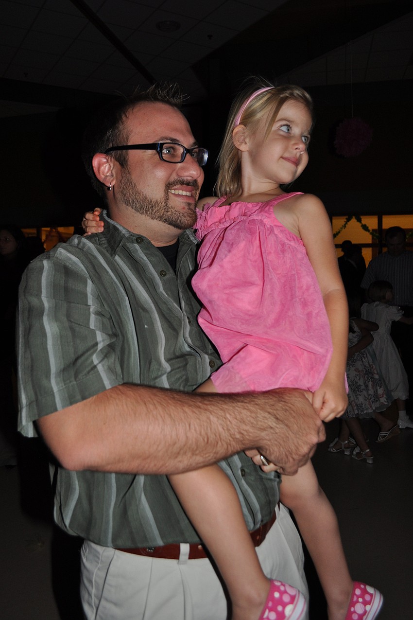 Michael Lander and his daughter, Eliza, keep their eyes on the dance floor.