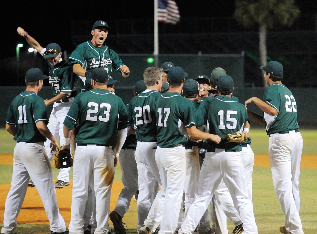 The Lakewood Ranch High baseball team rushes the mound in celebration after earning a trip to the Class 6A state semifinals with a 4-1 victory over Winter Haven in the Class 6A-Region finals May 11.