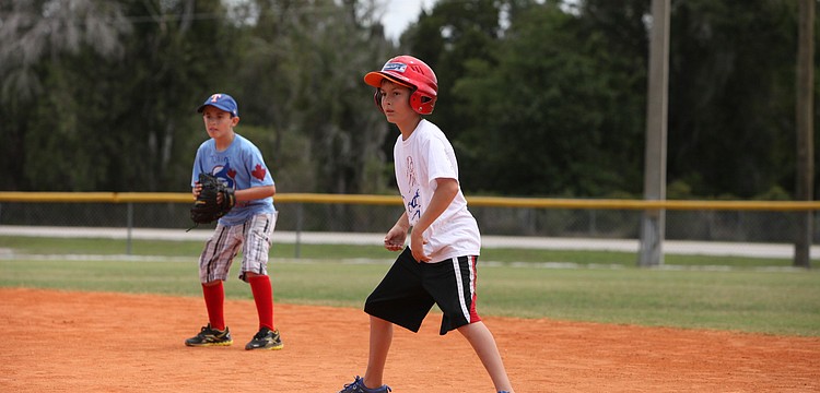RJ McLaughlin gets ready to make a run for second base while first baseman, Chase Harmon, watches closely.