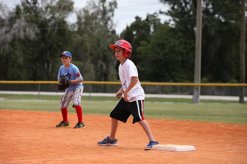 RJ McLaughlin gets ready to make a run for second base while first baseman, Chase Harmon, watches closely.