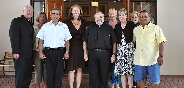 Msgr. Joseph Stearns poses with his staff including Deacon Kim Cohen, Arlene Luisa, Tony Garcia, Margaret Germain, Lynda Fischer, Diane Marcus, Donna Cohen and Ray Martinez, Sunday, May 20.