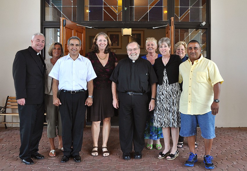 Msgr. Joseph Stearns poses with his staff including Deacon Kim Cohen, Arlene Luisa, Tony Garcia, Margaret Germain, Lynda Fischer, Diane Marcus, Donna Cohen and Ray Martinez, Sunday, May 20.