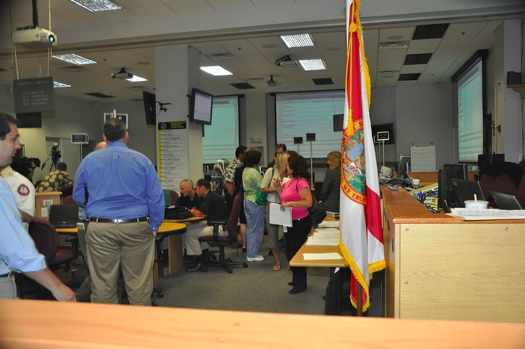Members of several county agencies chat after a hurricane training session at the Sarasota County Emergency Operations Center.