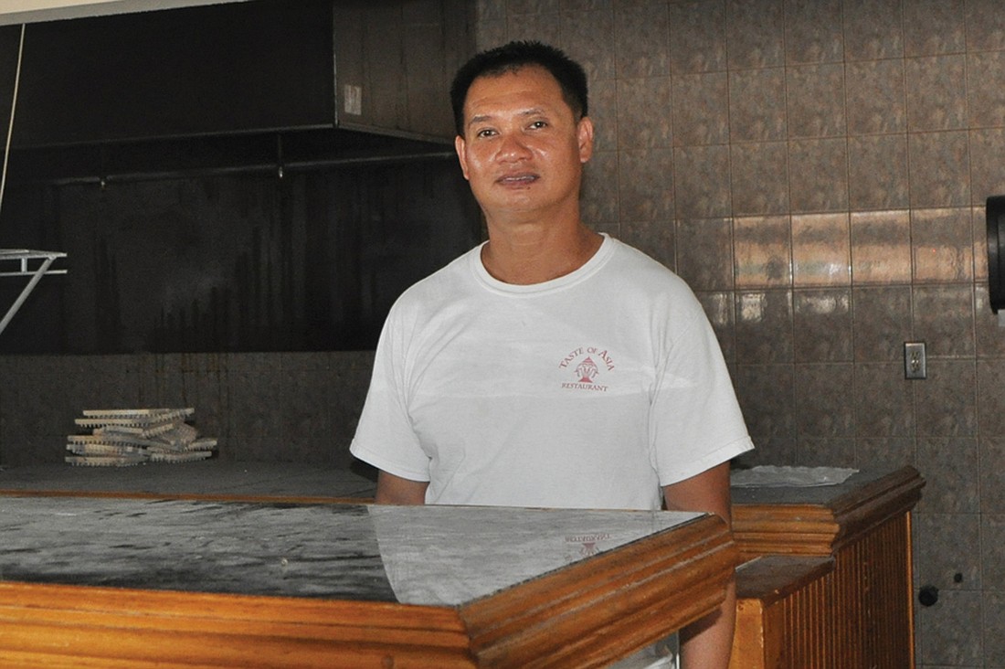 Lam Lum, owner of a Taste of Asia, stands behind the bar of the property he and is wife, Selina, will renovate to open their new restaurant.