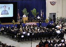 A screen projected a photo of Chief Albert Hogle while people talked about how much influence Hogle had on their careers and lives.